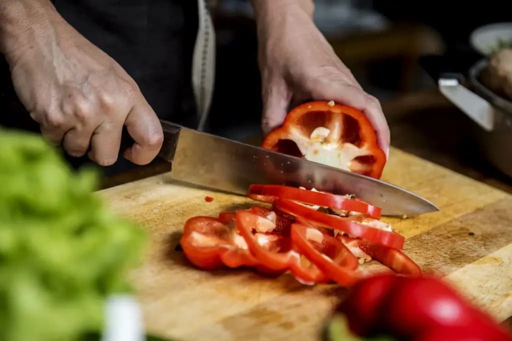 Someone chopping up red peppers to keep up with their hocho knife techniques.